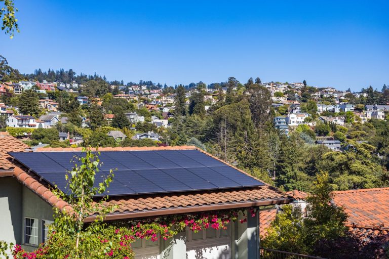 Woning met zonnepanelen en bomen eromheen